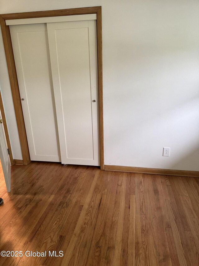 19 Callaghan Blvd, Charlton, NY 12019 - unfurnished bedroom featuring wood finished floors, a closet, and baseboards
