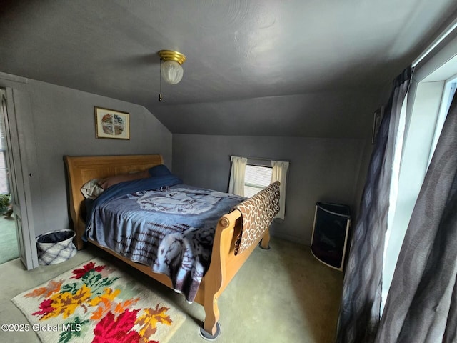 carpeted bedroom featuring ceiling fan and vaulted ceiling