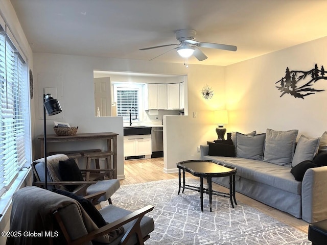 living room with a ceiling fan and light wood-style floors