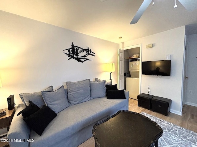 living area with ceiling fan, baseboards, and wood finished floors