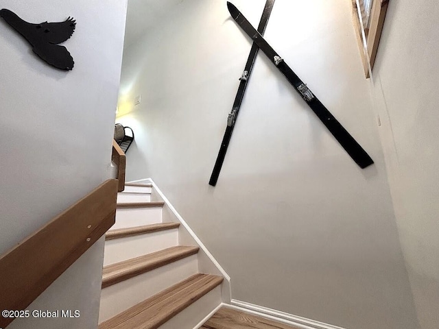 stairway featuring wood finished floors