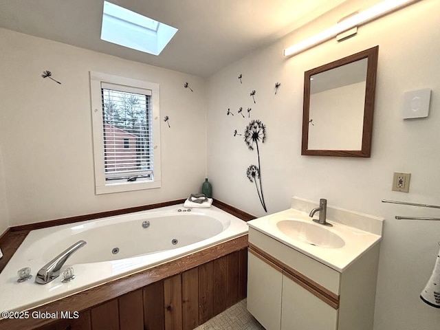 full bathroom with a skylight, vanity, and a jetted tub