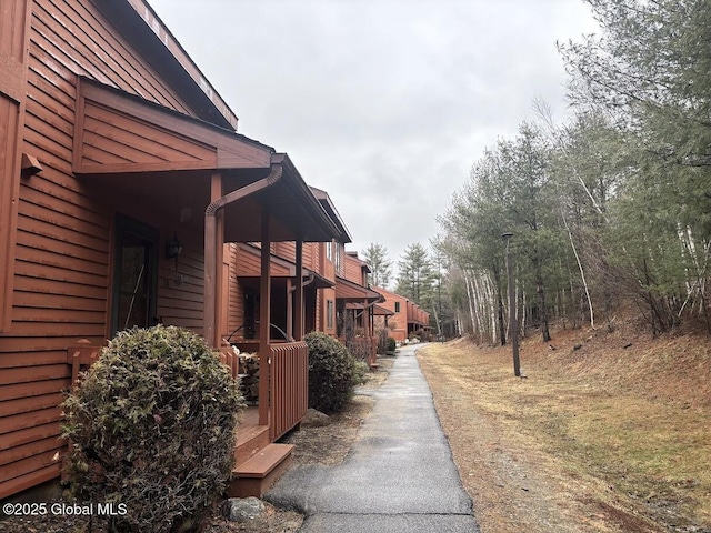 view of side of home featuring aphalt driveway