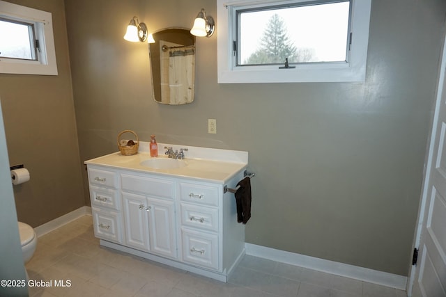 401 S 1st St, Northville, NY 12134 - bathroom with baseboards, vanity, a wealth of natural light, and toilet