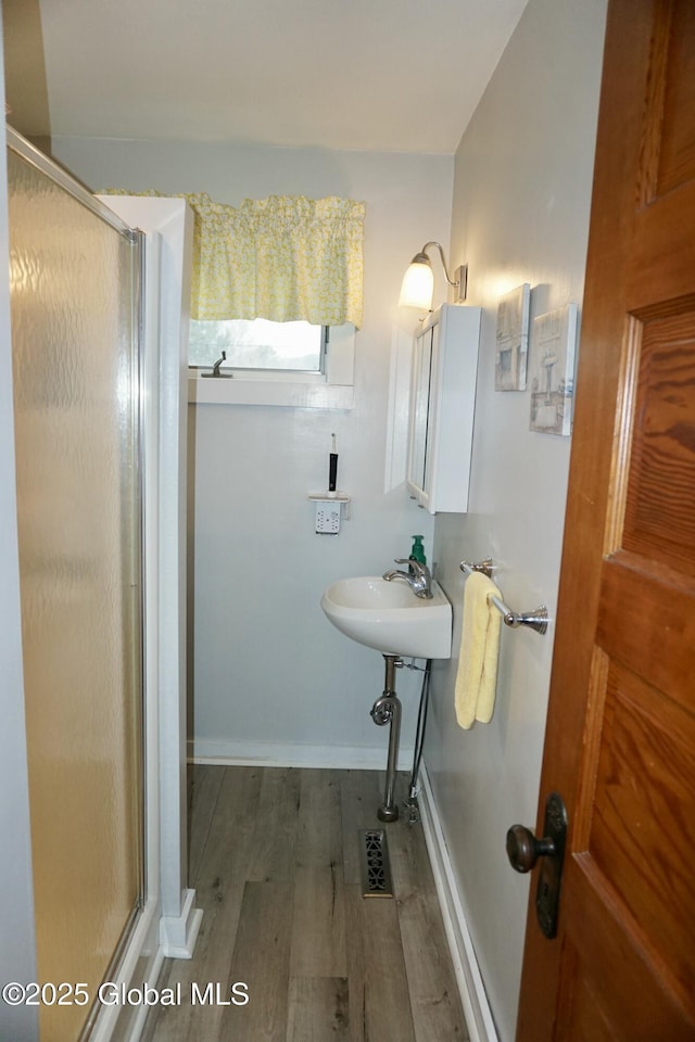401 S 1st St, Northville, NY 12134 - full bath featuring a shower stall, wood finished floors, visible vents, and baseboards