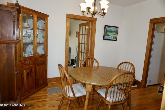401 S 1st St, Northville, NY 12134 - dining space with light wood-type flooring, baseboards, an inviting chandelier, and visible vents