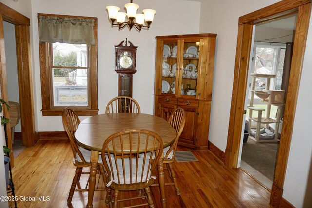 401 S 1st St, Northville, NY 12134 - dining space featuring an inviting chandelier, light wood finished floors, and plenty of natural light