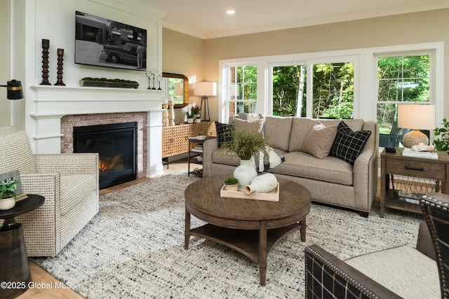 living room featuring a fireplace with flush hearth, crown molding, wood finished floors, and recessed lighting