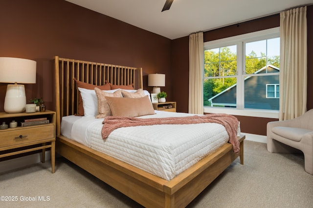 carpeted bedroom with a ceiling fan and baseboards