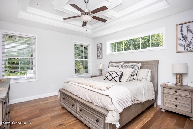 bedroom with multiple windows, ornamental molding, and wood finished floors