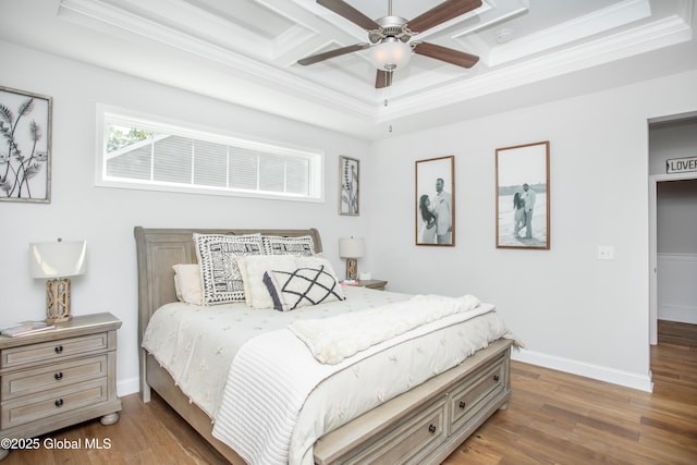 bedroom with ornamental molding, wood finished floors, and coffered ceiling