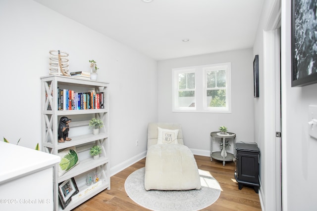 sitting room featuring baseboards and wood finished floors