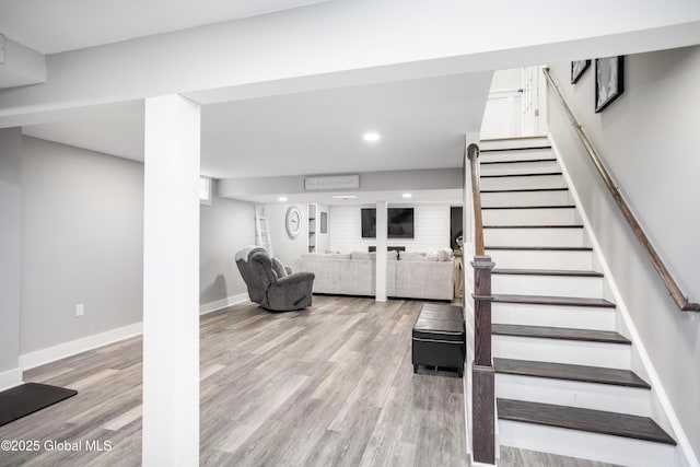 staircase featuring baseboards, recessed lighting, and wood finished floors