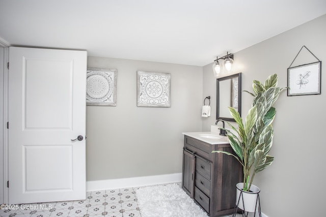 bathroom featuring baseboards and vanity