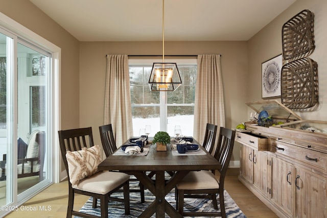 dining room featuring a chandelier and light wood-type flooring