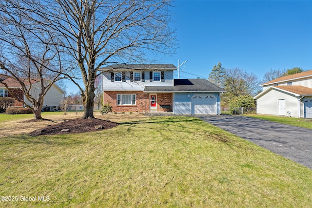 87 Dorchester Ave, Bethlehem, NY 12158 - view of front facade featuring fence, a garage, brick siding, a front yard, and aphalt driveway