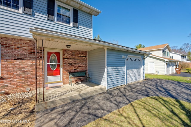 87 Dorchester Ave, Bethlehem, NY 12158 - view of front of home featuring brick siding, driveway, and covered porch