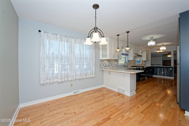 87 Dorchester Ave, Bethlehem, NY 12158 - kitchen with stainless steel range oven, a peninsula, visible vents, and a sink