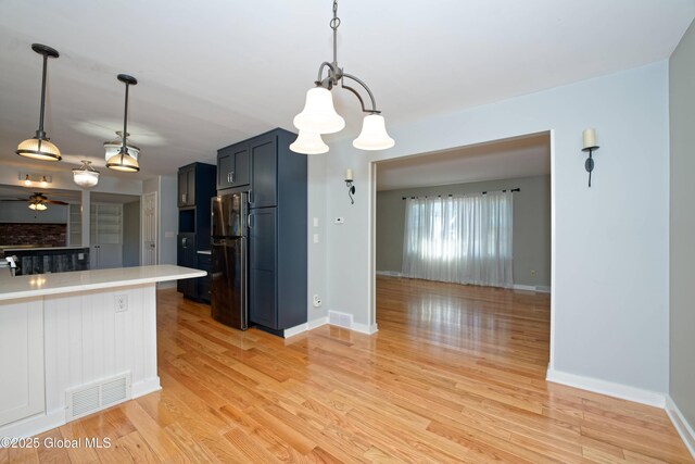 87 Dorchester Ave, Bethlehem, NY 12158 - kitchen featuring light countertops, freestanding refrigerator, visible vents, and baseboards
