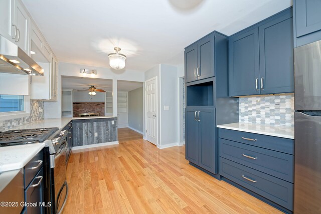 87 Dorchester Ave, Bethlehem, NY 12158 - kitchen featuring light countertops, decorative backsplash, appliances with stainless steel finishes, and under cabinet range hood