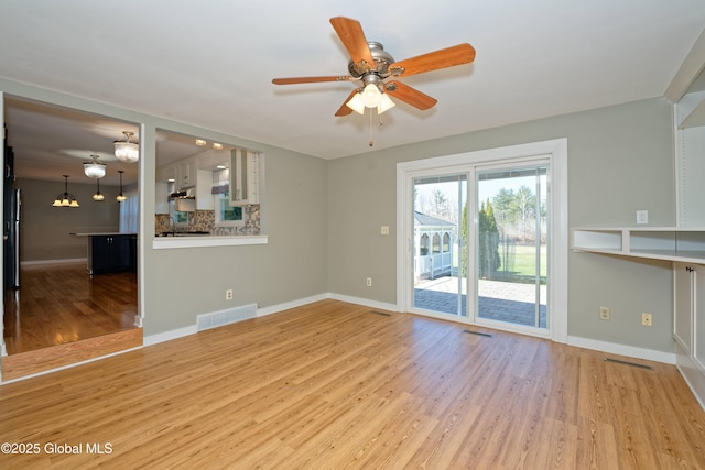 87 Dorchester Ave, Bethlehem, NY 12158 - unfurnished living room featuring ceiling fan, baseboards, wood finished floors, and visible vents