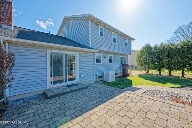 87 Dorchester Ave, Bethlehem, NY 12158 - rear view of property featuring a lawn, roof with shingles, central AC, and a patio