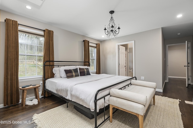 214 Vosenkill Rd, Athens, NY 12015 - bedroom featuring a notable chandelier, dark wood-style floors, baseboards, recessed lighting, and ensuite bath
