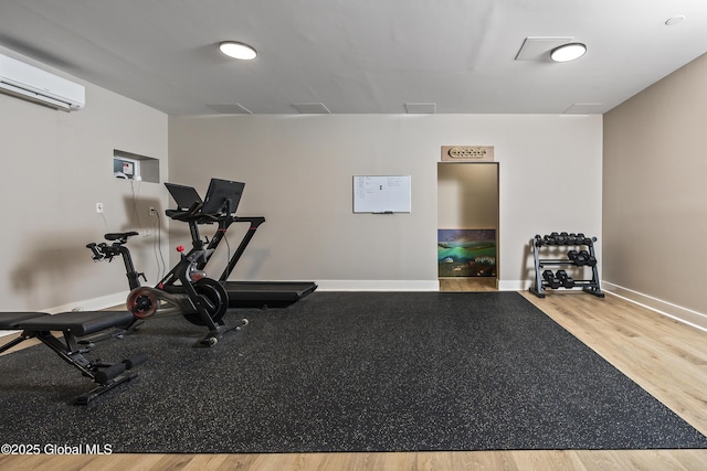 214 Vosenkill Rd, Athens, NY 12015 - workout area with baseboards, a wall unit AC, and wood finished floors