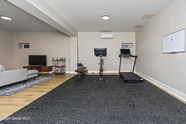 214 Vosenkill Rd, Athens, NY 12015 - exercise area featuring baseboards, wood finished floors, and an AC wall unit