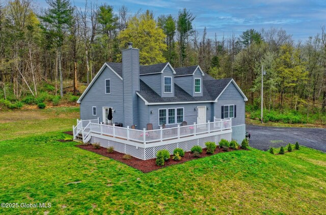 214 Vosenkill Rd, Athens, NY 12015 - view of front of home with a deck, a wooded view, a chimney, and a front lawn