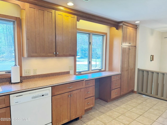 kitchen featuring recessed lighting, light tile patterned floors, built in desk, and white dishwasher