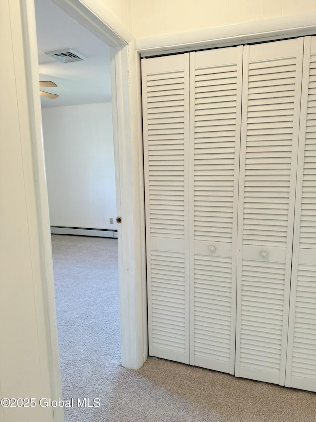 details featuring visible vents, carpet, and a baseboard radiator
