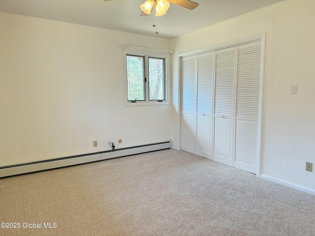 unfurnished bedroom with a closet, baseboard heating, light carpet, ceiling fan, and baseboards