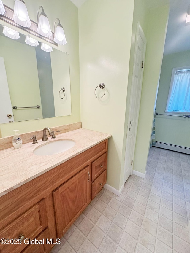 bathroom with baseboards, tile patterned flooring, vanity, and a baseboard radiator