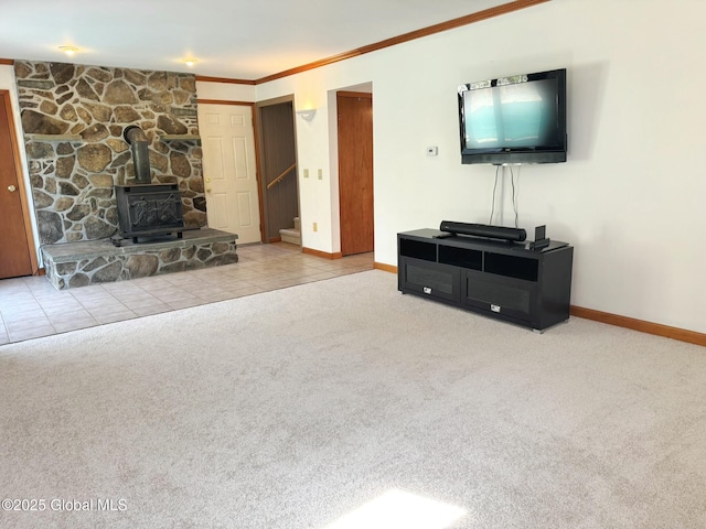 living area featuring a wood stove, carpet flooring, stairway, and baseboards