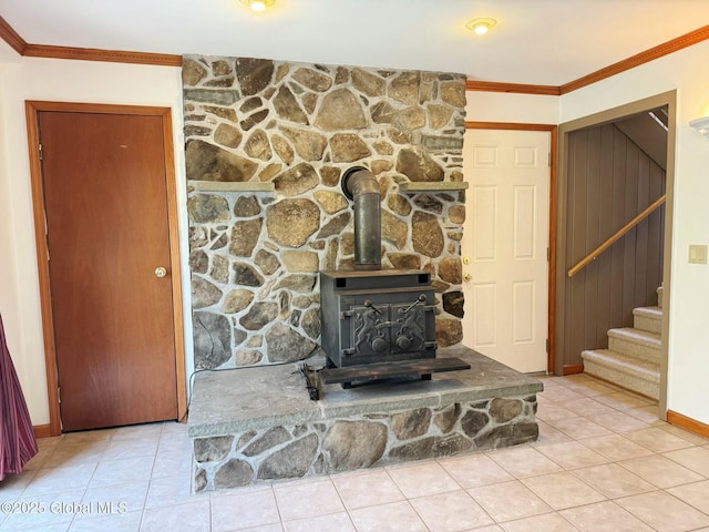 room details featuring baseboards, a wood stove, and ornamental molding