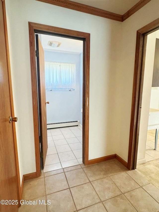 hall featuring baseboards, light tile patterned floors, ornamental molding, and a baseboard radiator