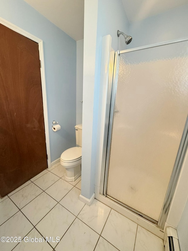 full bath with baseboards, baseboard heating, a shower stall, and toilet