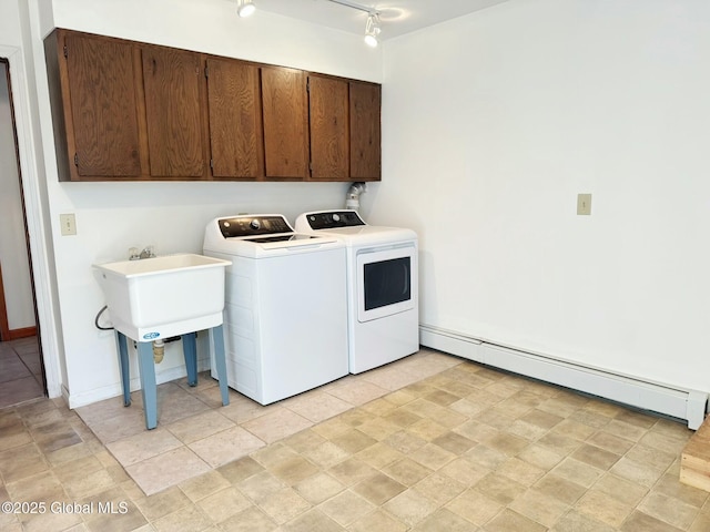 laundry area with a baseboard heating unit, cabinet space, and washer and clothes dryer