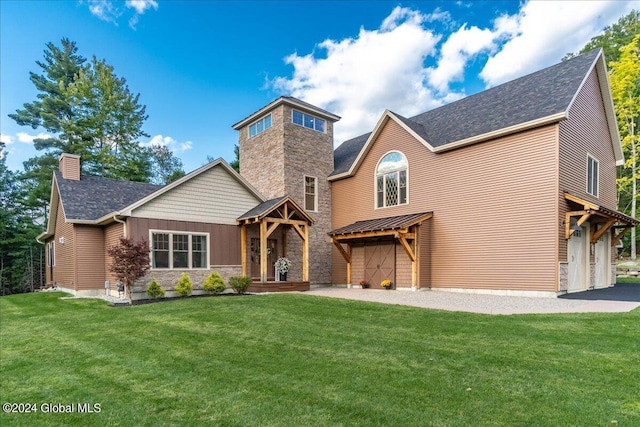 craftsman house featuring a front lawn, a chimney, roof with shingles, and a garage