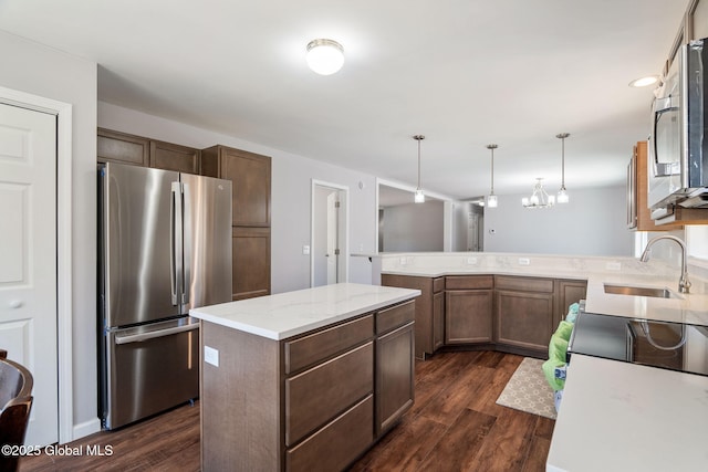 152 Ingersoll Rd, Wilton, NY 12866 - kitchen with dark wood finished floors, stainless steel appliances, hanging light fixtures, and a sink