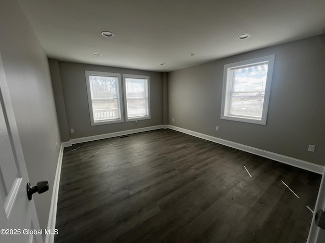 empty room with recessed lighting, baseboards, and dark wood finished floors