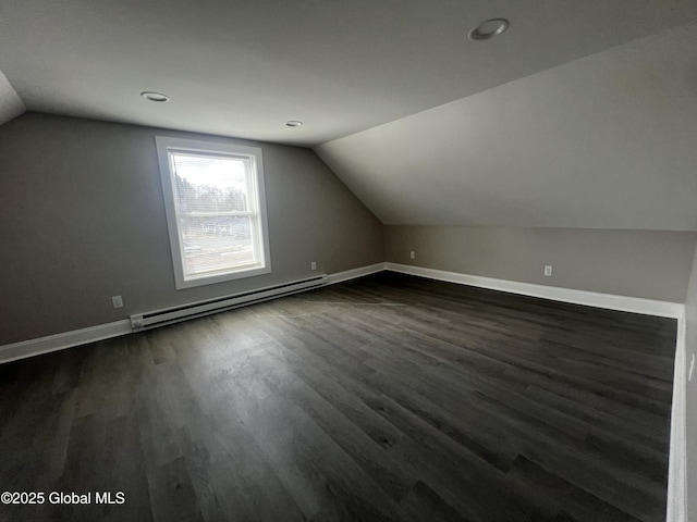 bonus room featuring lofted ceiling, baseboards, baseboard heating, dark wood-style floors, and recessed lighting