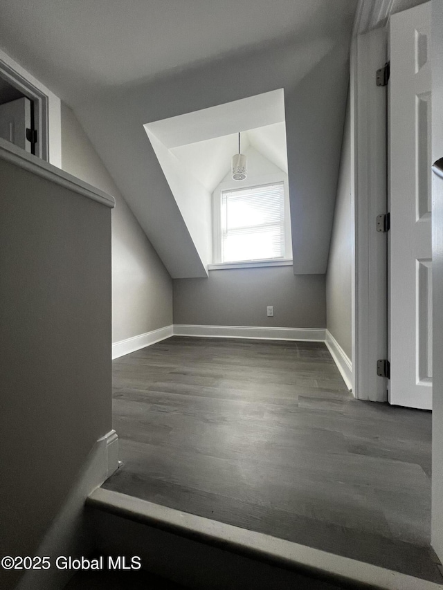 bonus room featuring baseboards, vaulted ceiling, and wood finished floors