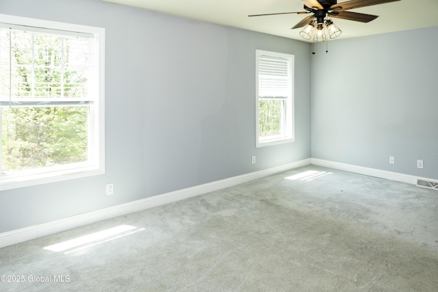 empty room with a ceiling fan, carpet flooring, and baseboards