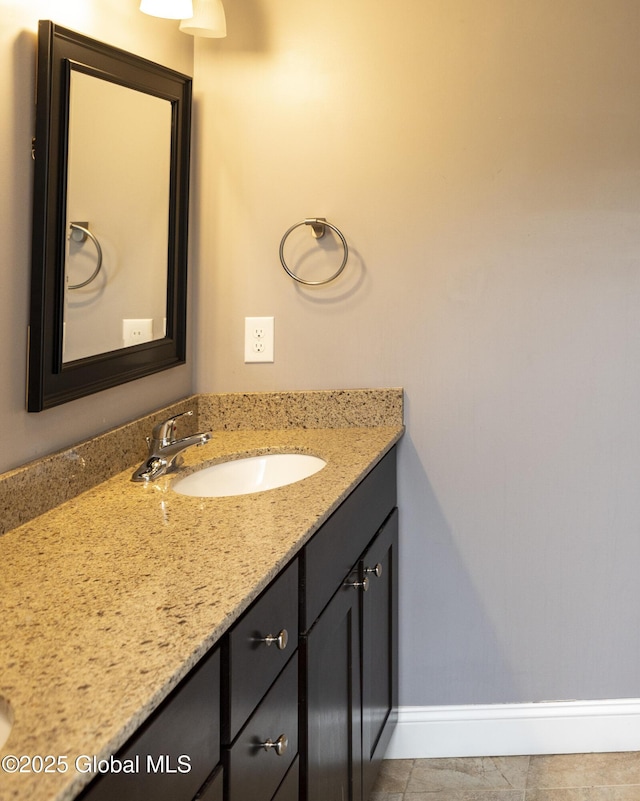 bathroom featuring vanity, baseboards, and tile patterned flooring