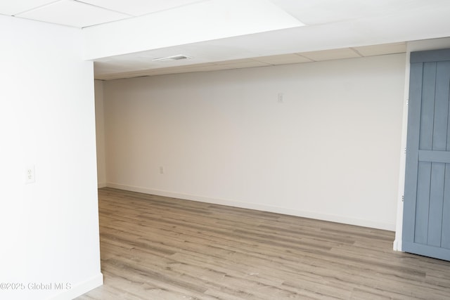 finished basement with light wood-style flooring and baseboards