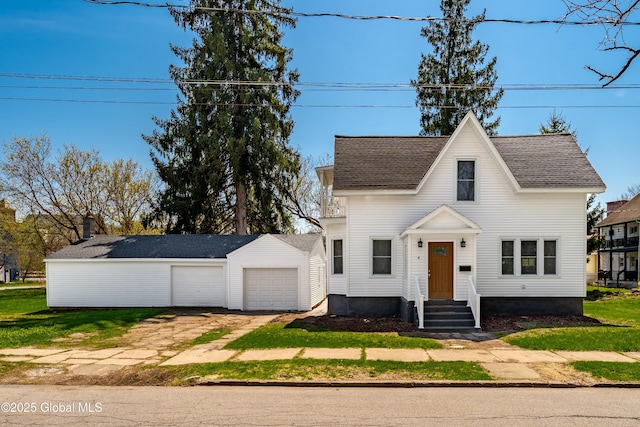 view of front of property with a garage, an outdoor structure, and a shingled roof
