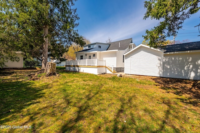 back of house featuring a yard and a wooden deck