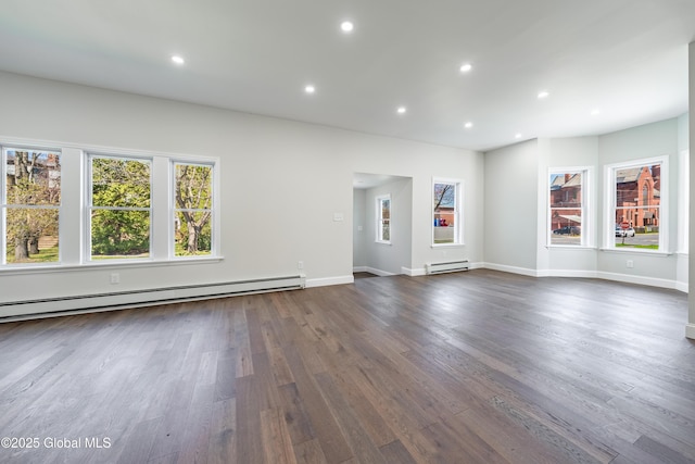 unfurnished living room with dark wood-style floors, recessed lighting, a baseboard heating unit, and baseboards